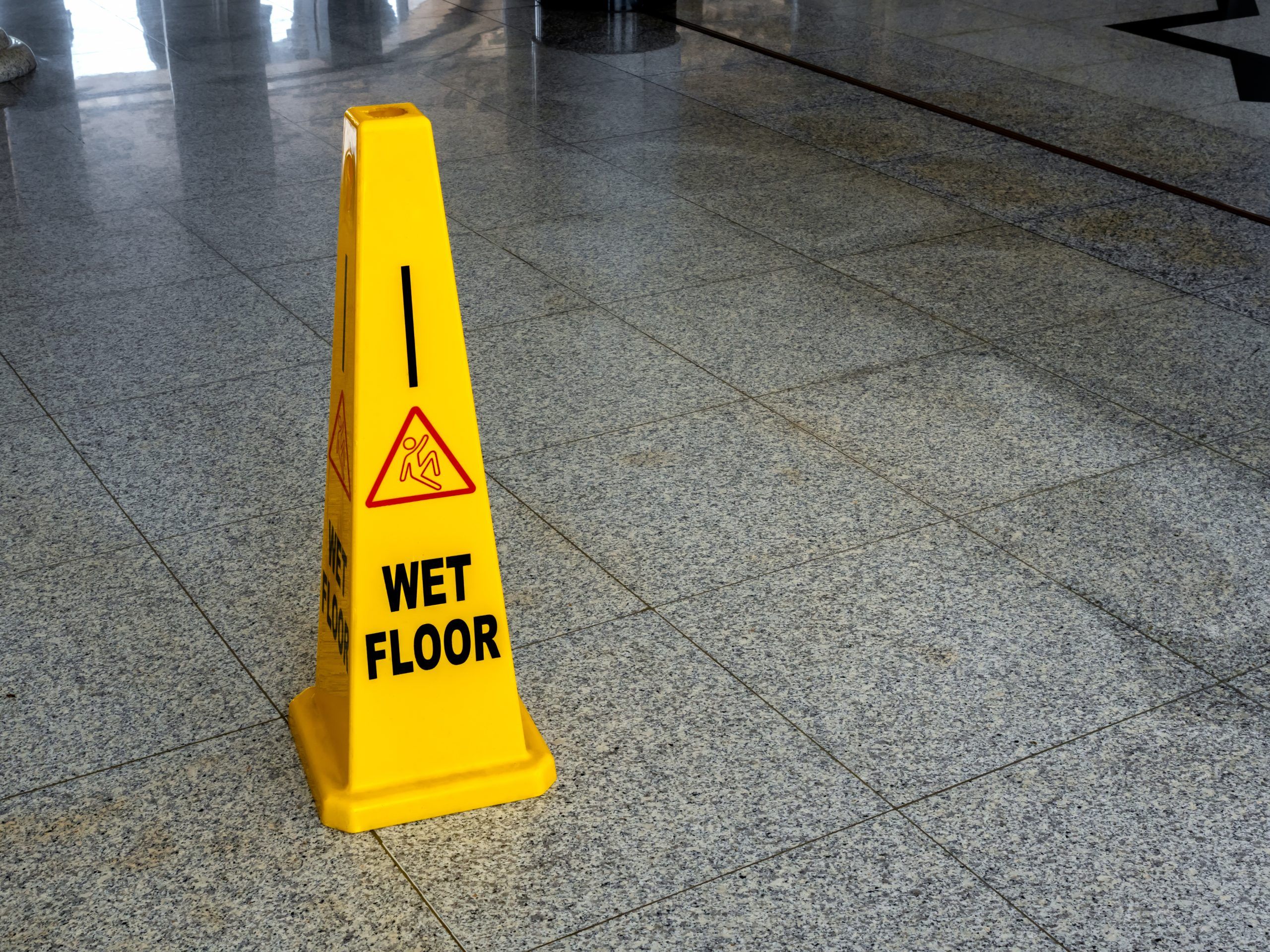 wet floor yellow caution sign cone